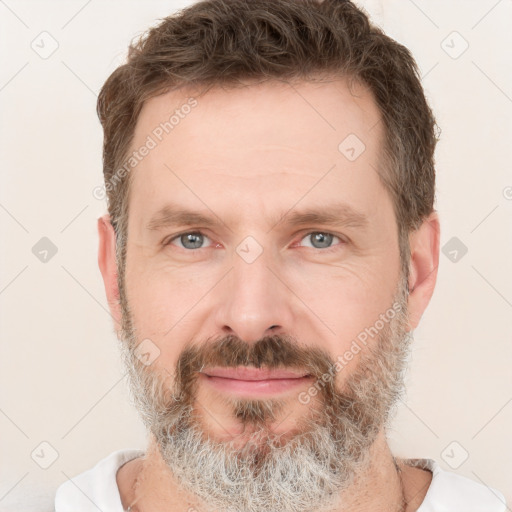 Joyful white adult male with short  brown hair and grey eyes