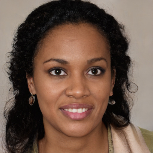 Joyful black young-adult female with long  brown hair and brown eyes