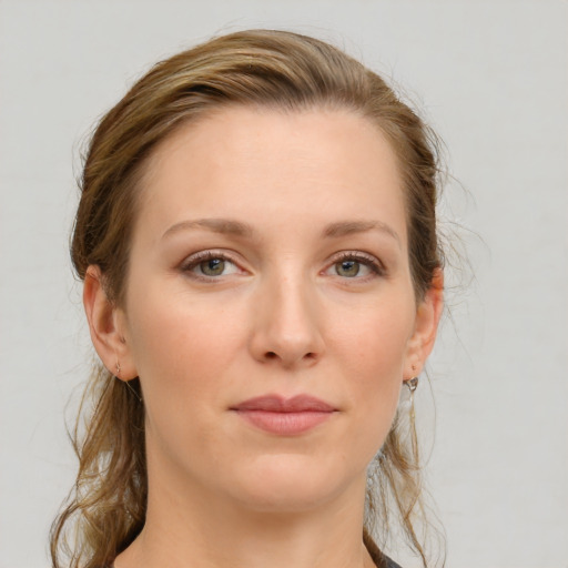 Joyful white young-adult female with medium  brown hair and grey eyes