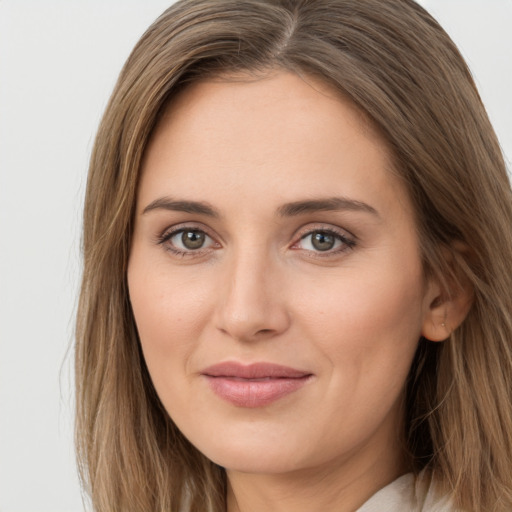 Joyful white young-adult female with long  brown hair and grey eyes