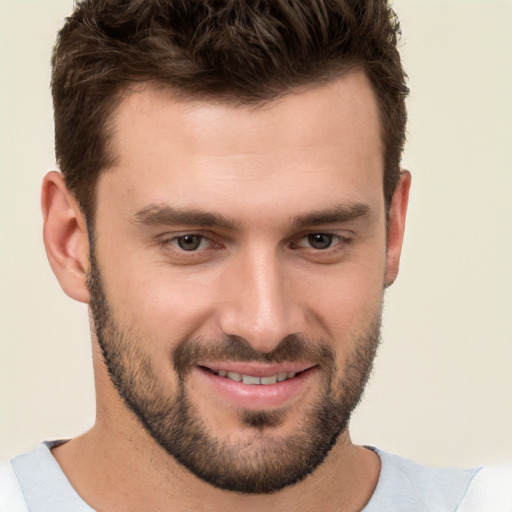 Joyful white young-adult male with short  brown hair and brown eyes