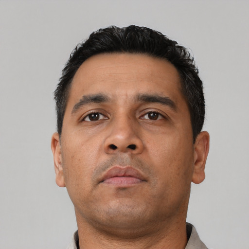 Neutral latino adult male with short  black hair and brown eyes