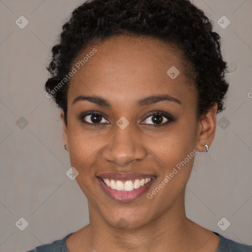 Joyful black young-adult female with short  black hair and brown eyes