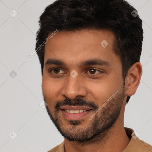 Joyful white young-adult male with short  black hair and brown eyes