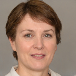 Joyful white adult female with medium  brown hair and grey eyes