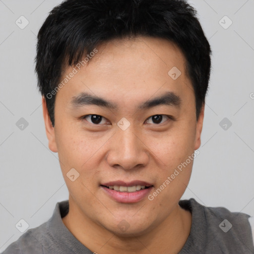 Joyful asian young-adult male with short  black hair and brown eyes