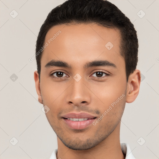 Joyful latino young-adult male with short  black hair and brown eyes