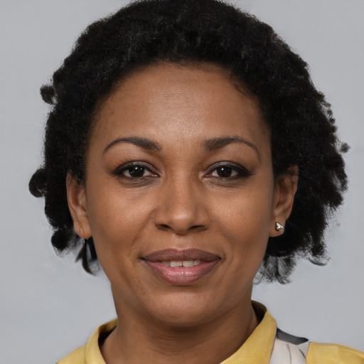 Joyful latino adult female with short  brown hair and brown eyes