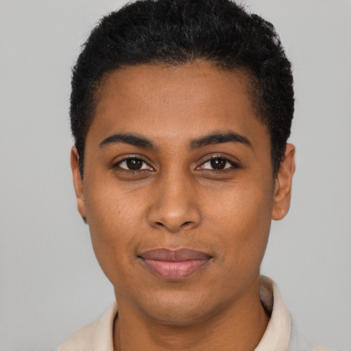 Joyful black young-adult female with short  black hair and brown eyes