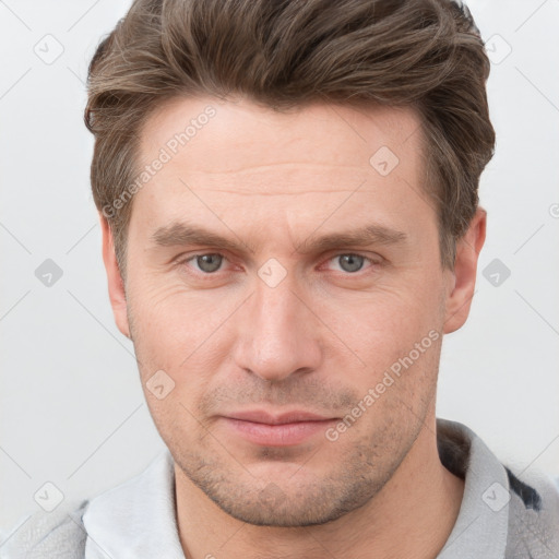 Joyful white adult male with short  brown hair and grey eyes