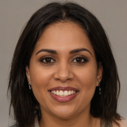 Joyful white young-adult female with medium  brown hair and brown eyes