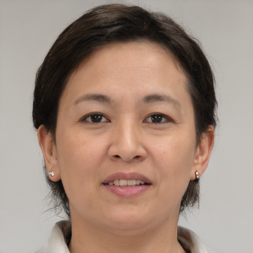Joyful white adult female with medium  brown hair and brown eyes