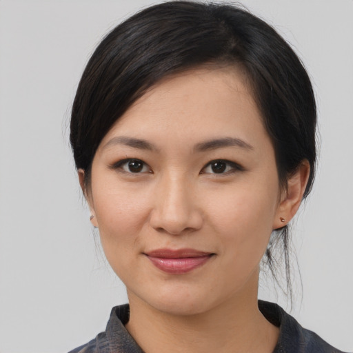 Joyful asian young-adult female with medium  black hair and brown eyes
