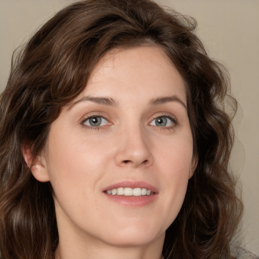 Joyful white young-adult female with medium  brown hair and green eyes