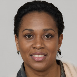 Joyful black young-adult female with short  brown hair and brown eyes