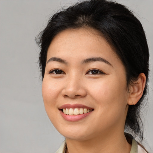 Joyful asian young-adult female with medium  brown hair and brown eyes