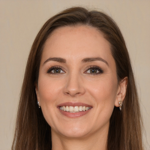 Joyful white young-adult female with long  brown hair and brown eyes