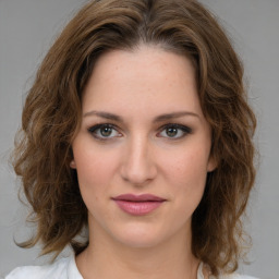 Joyful white young-adult female with medium  brown hair and green eyes