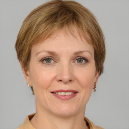 Joyful white adult female with medium  brown hair and grey eyes