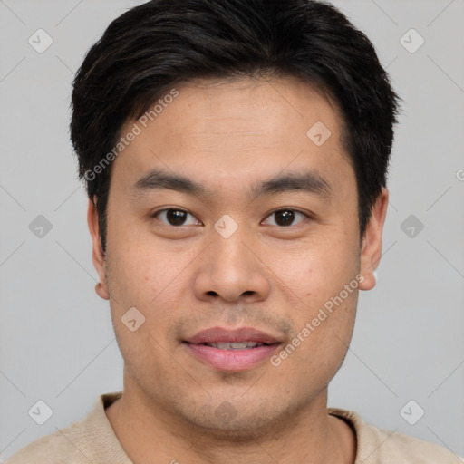 Joyful asian young-adult male with short  brown hair and brown eyes