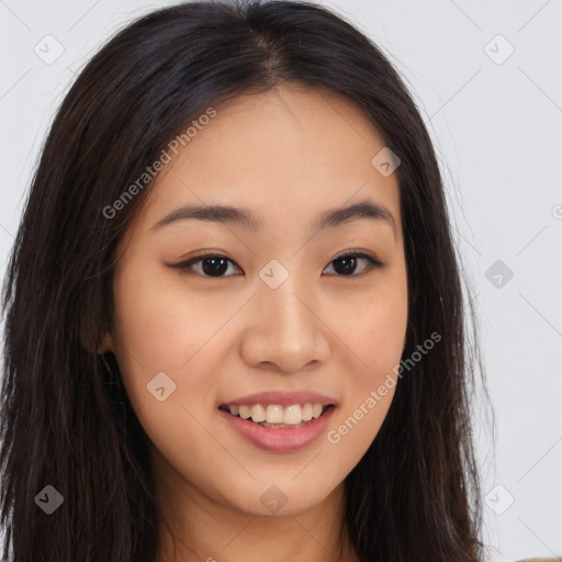 Joyful asian young-adult female with long  brown hair and brown eyes