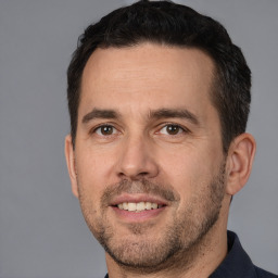 Joyful white adult male with short  brown hair and brown eyes