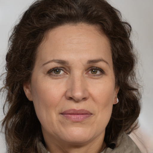 Joyful white adult female with long  brown hair and brown eyes