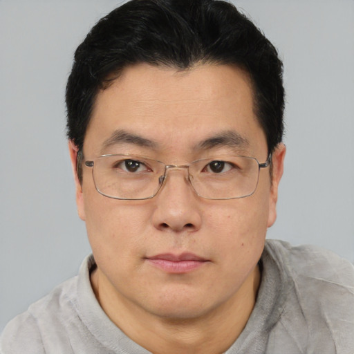 Neutral asian adult male with short  brown hair and brown eyes