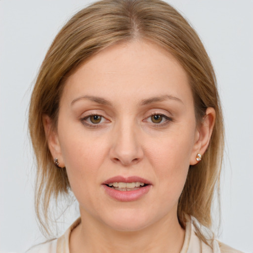 Joyful white young-adult female with medium  brown hair and blue eyes