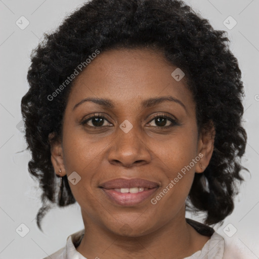 Joyful black adult female with short  brown hair and brown eyes