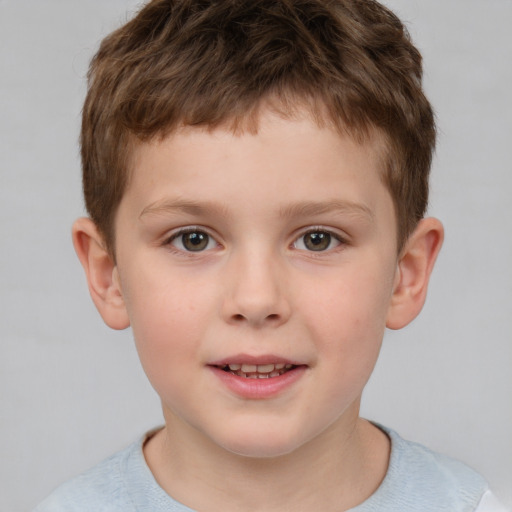 Joyful white child male with short  brown hair and brown eyes