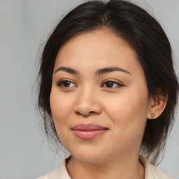 Joyful asian young-adult female with medium  brown hair and brown eyes