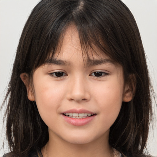 Joyful white child female with long  brown hair and brown eyes