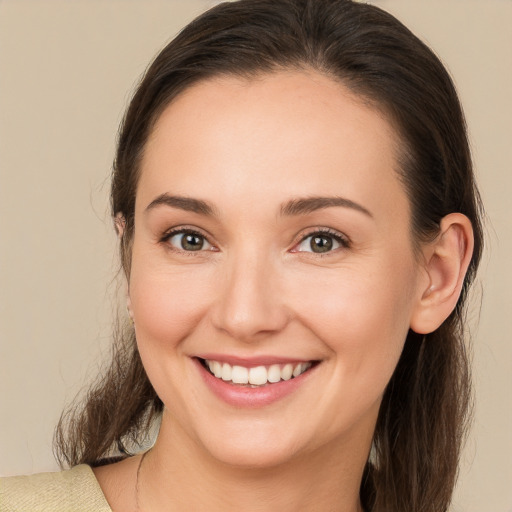 Joyful white young-adult female with medium  brown hair and brown eyes