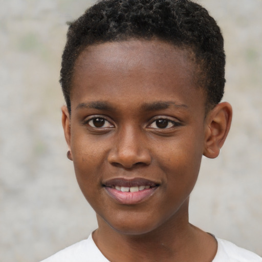 Joyful black child male with short  brown hair and brown eyes