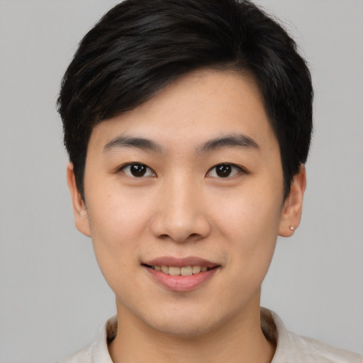 Joyful asian young-adult male with short  black hair and brown eyes