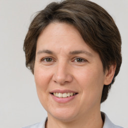 Joyful white adult female with medium  brown hair and grey eyes