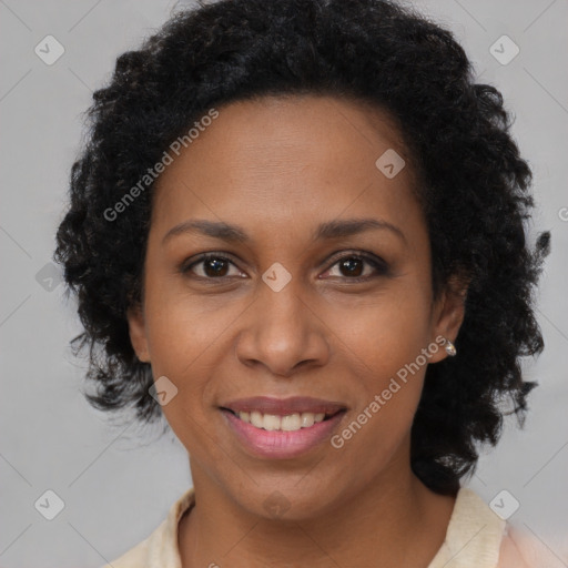 Joyful black adult female with medium  brown hair and brown eyes