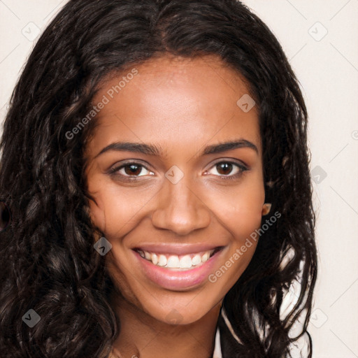 Joyful black young-adult female with long  brown hair and brown eyes