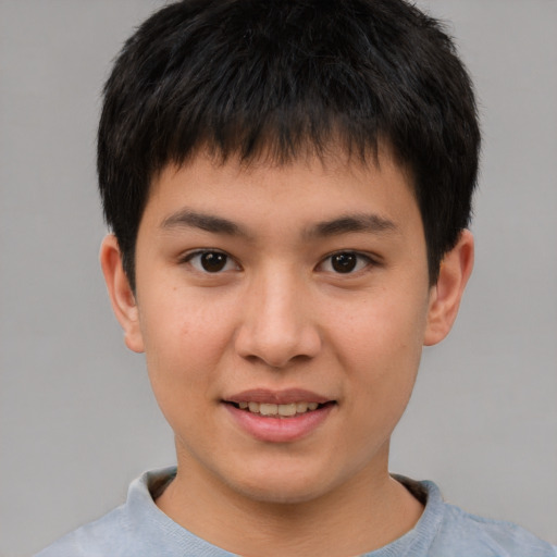 Joyful asian child male with short  brown hair and brown eyes