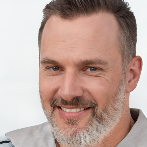 Joyful white middle-aged male with short  brown hair and brown eyes