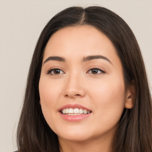 Joyful white young-adult female with long  brown hair and brown eyes