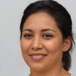 Joyful latino young-adult female with medium  brown hair and brown eyes