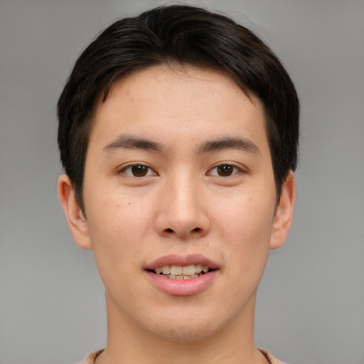 Joyful asian young-adult male with short  brown hair and brown eyes