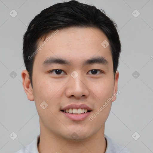 Joyful asian young-adult male with short  black hair and brown eyes