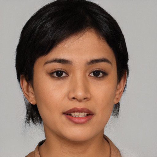 Joyful asian young-adult female with medium  black hair and brown eyes
