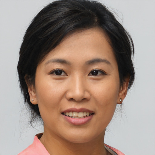 Joyful asian young-adult female with medium  brown hair and brown eyes