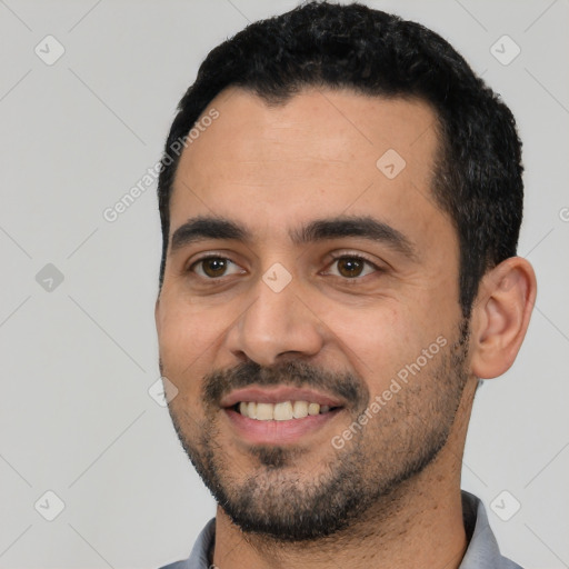 Joyful latino young-adult male with short  black hair and brown eyes