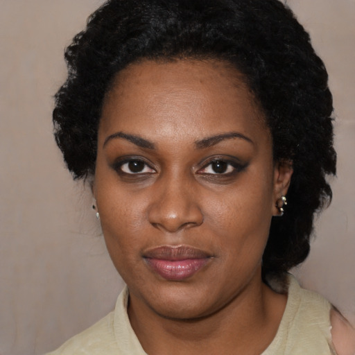 Joyful black young-adult female with medium  black hair and brown eyes