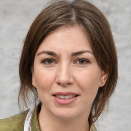 Joyful white adult female with medium  brown hair and brown eyes